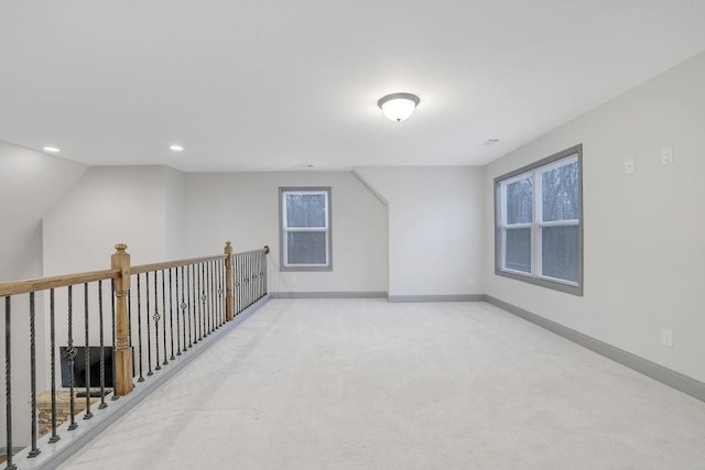 bonus room featuring light carpet