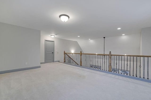 unfurnished room featuring light carpet and vaulted ceiling