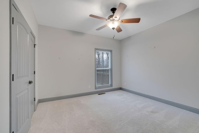 carpeted empty room with ceiling fan