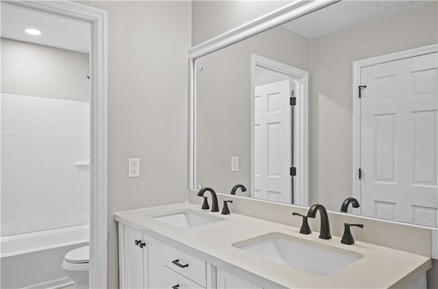 1819 Laurel Ridge Dr SW, Conyers, GA 30094 - bathroom with toilet, double vanity, recessed lighting, and shower / bath combination