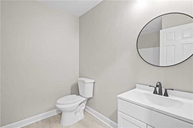 1819 Laurel Ridge Dr SW, Conyers, GA 30094 - bathroom featuring baseboards, toilet, vanity, and wood finished floors