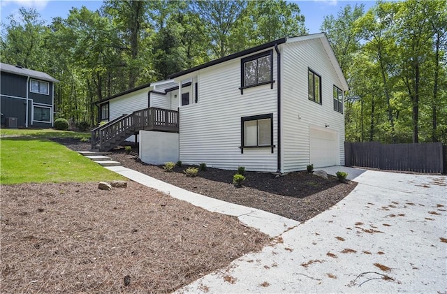 1819 Laurel Ridge Dr SW, Conyers, GA 30094 - view of side of property featuring an attached garage, stairs, driveway, and a wooden deck