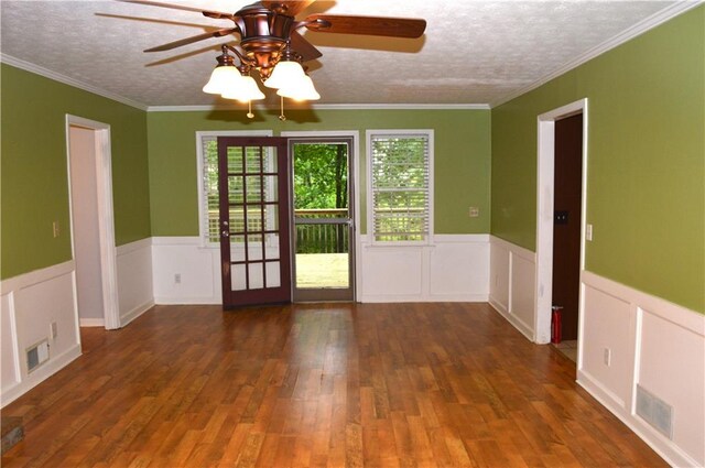 interior space with a textured ceiling, a ceiling fan, hardwood / wood-style flooring, and visible vents