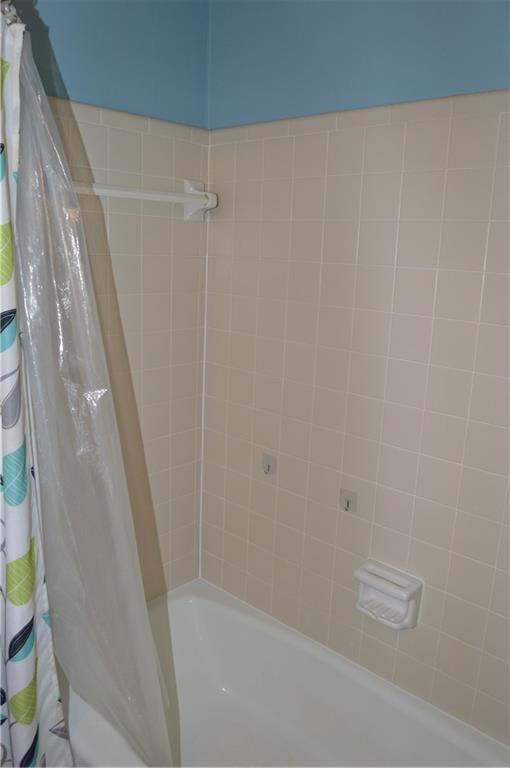 full bathroom with shower / bath combo with shower curtain