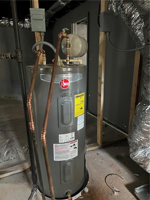 utility room with electric water heater