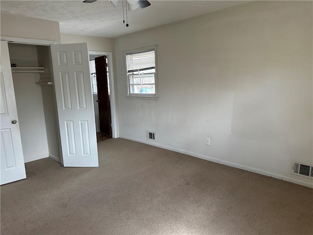 2195 Wilson Rd, Conyers, GA 30012 - unfurnished bedroom with carpet, a closet, baseboards, ceiling fan, and a textured ceiling