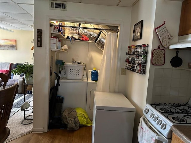 2195 Wilson Rd, Conyers, GA 30012 - laundry area featuring washing machine and clothes dryer and wood finished floors