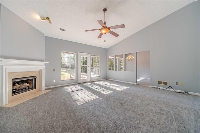 unfurnished living room featuring light carpet, ceiling fan with notable chandelier, and high vaulted ceiling