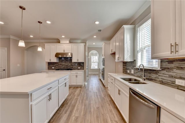 kitchen with white cabinetry, sink, decorative light fixtures, and stainless steel dishwasher