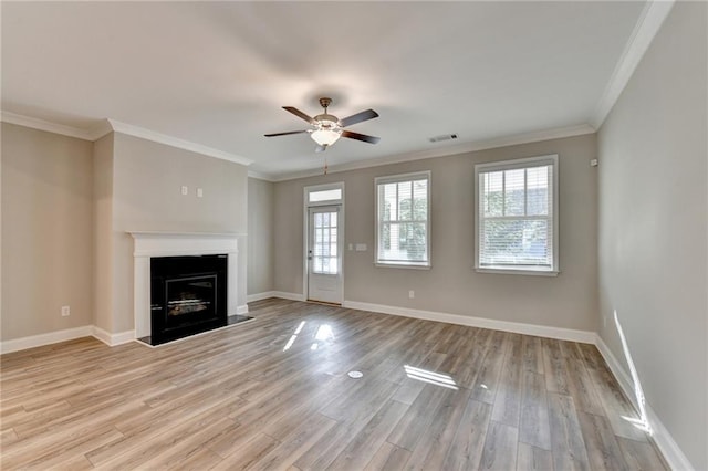 unfurnished living room featuring ceiling fan, ornamental molding, and light hardwood / wood-style floors