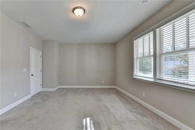 empty room featuring light carpet