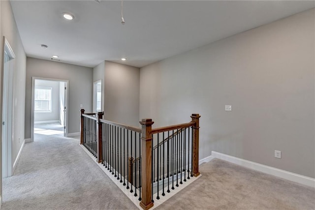 hallway featuring light colored carpet