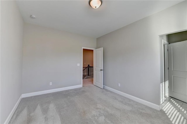 unfurnished bedroom featuring light carpet