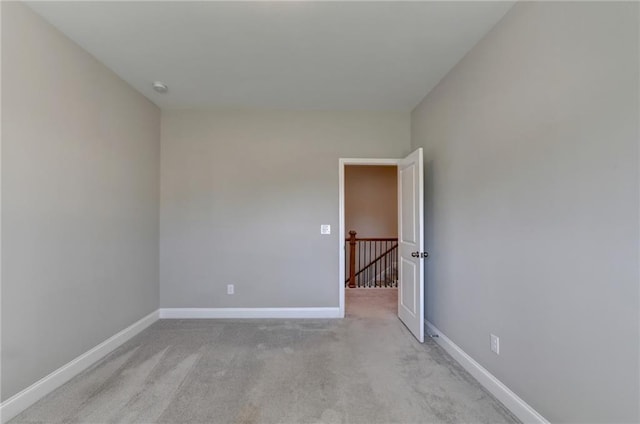 empty room featuring light colored carpet