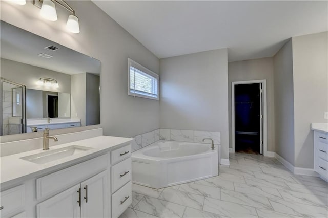 bathroom with vanity and independent shower and bath