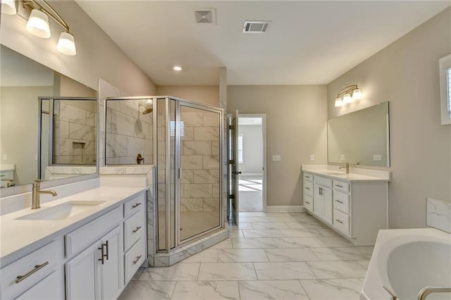 bathroom featuring vanity and independent shower and bath