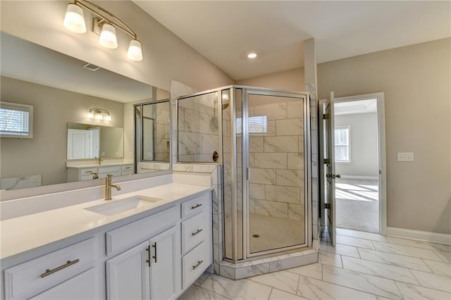 bathroom featuring vanity and a shower with shower door