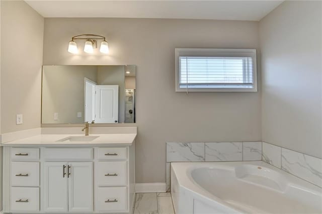 bathroom with vanity and a tub to relax in