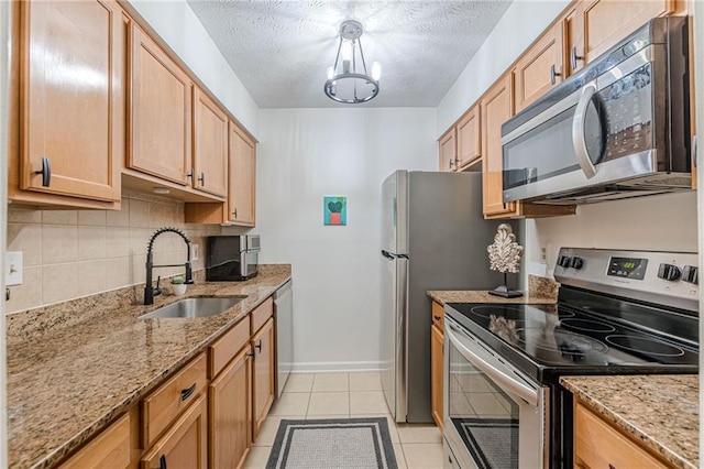 3135 Seven Pines Ct Unit 201, Atlanta, GA 30339 - kitchen featuring appliances with stainless steel finishes, a chandelier, light tile patterned flooring, backsplash, and light stone countertops