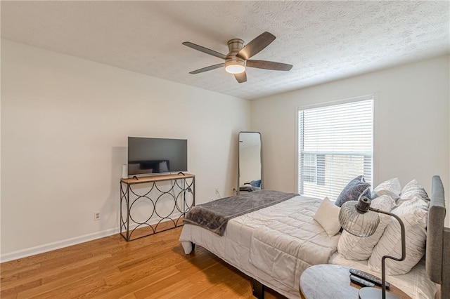 3135 Seven Pines Ct Unit 201, Atlanta, GA 30339 - bedroom featuring light wood-style flooring, a textured ceiling, and ceiling fan