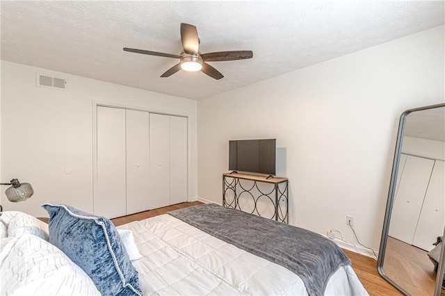 3135 Seven Pines Ct Unit 201, Atlanta, GA 30339 - bedroom featuring wood finished floors, a closet, ceiling fan, and a textured ceiling