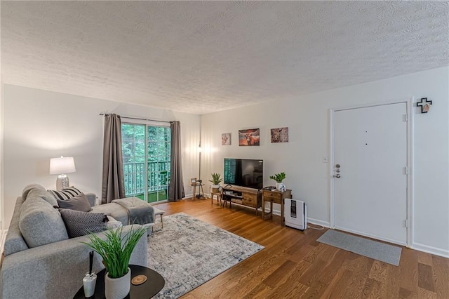 3135 Seven Pines Ct Unit 201, Atlanta, GA 30339 - living room featuring a textured ceiling and wood finished floors