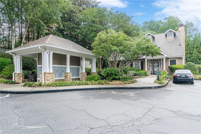 3135 Seven Pines Ct Unit 201, Atlanta, GA 30339 - view of front of property with a chimney, stone siding, and a shingled roof