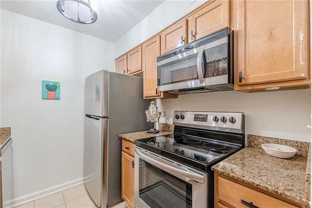 3135 Seven Pines Ct Unit 201, Atlanta, GA 30339 - kitchen featuring stainless steel appliances, light brown cabinets, light stone countertops, and light tile patterned flooring