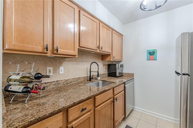 3135 Seven Pines Ct Unit 201, Atlanta, GA 30339 - kitchen with appliances with stainless steel finishes, backsplash, light tile patterned floors, light stone counters, and a textured ceiling