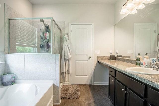 bathroom with shower with separate bathtub, vanity, and hardwood / wood-style floors