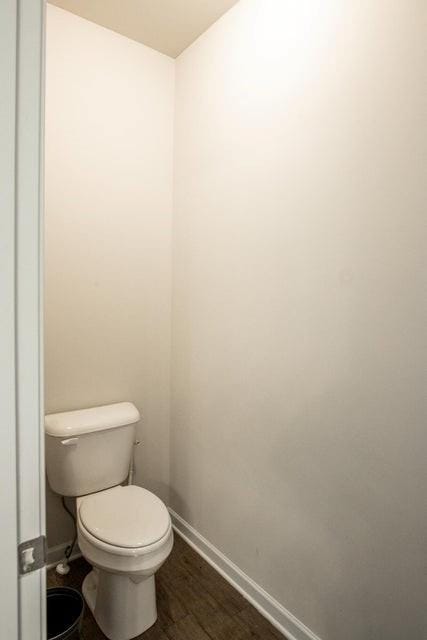 bathroom with wood-type flooring and toilet