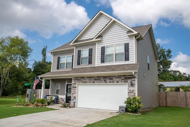 craftsman house featuring a garage and a front yard