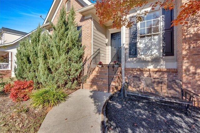 view of property hidden behind natural elements featuring a front lawn