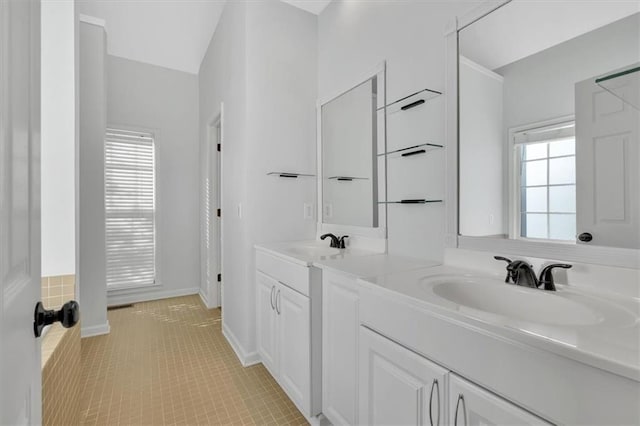 full bathroom with plenty of natural light, a sink, and tile patterned floors