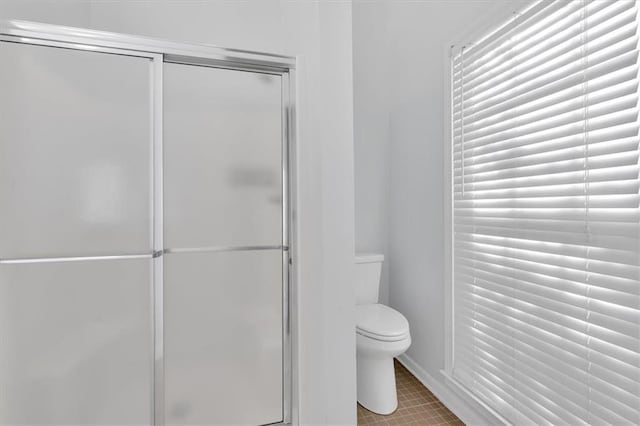 bathroom with toilet and a shower stall