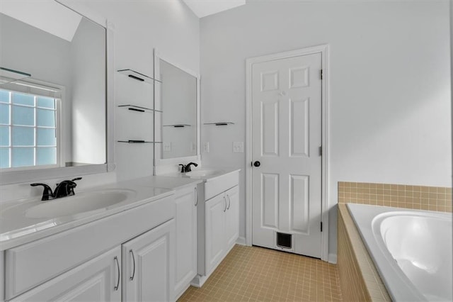 full bath with double vanity, a garden tub, a sink, and tile patterned floors