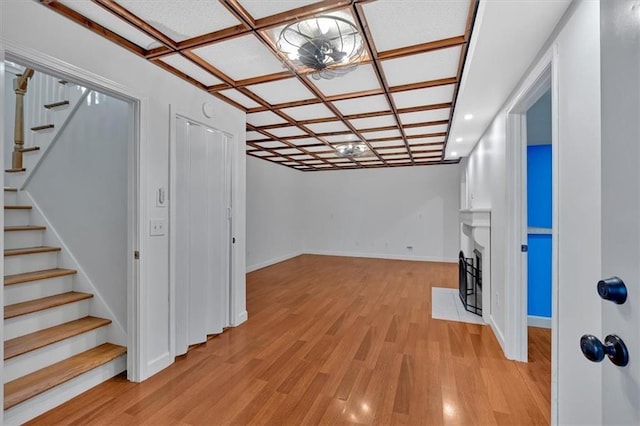 basement featuring baseboards, stairway, light wood-style floors, a fireplace, and recessed lighting