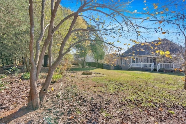 view of yard featuring a deck and fence