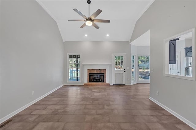 unfurnished living room with high vaulted ceiling, a fireplace, a ceiling fan, and baseboards