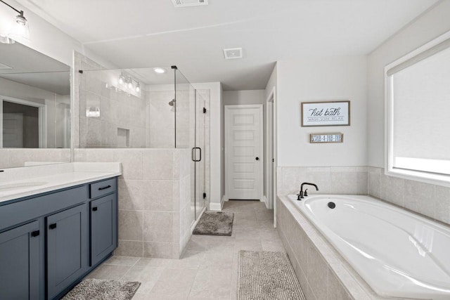 69 Saint Ives Cir, Winder, GA 30680 - full bathroom featuring vanity, a bath, a shower stall, and tile patterned flooring