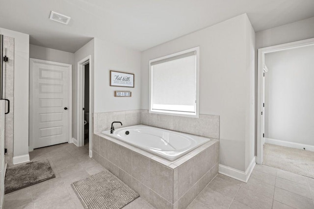 69 Saint Ives Cir, Winder, GA 30680 - full bath featuring a bath, tile patterned floors, and a stall shower