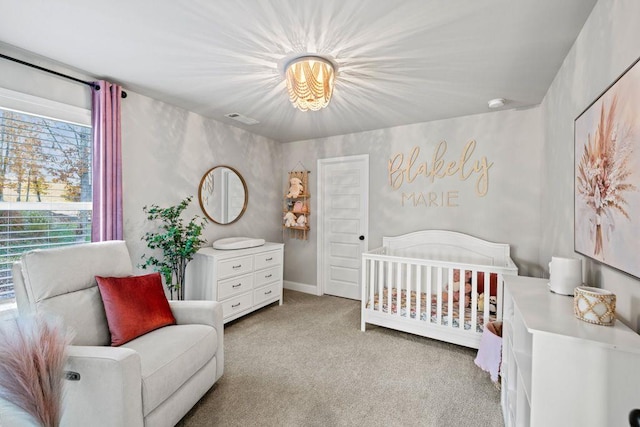 bedroom featuring light carpet, visible vents, and a crib