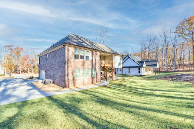 69 Saint Ives Cir, Winder, GA 30680 - back of house with brick siding, a yard, and a balcony