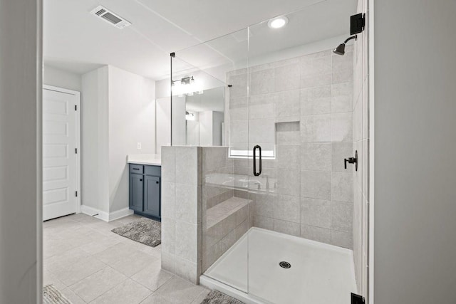 bathroom with visible vents, a shower stall, vanity, baseboards, and tile patterned floors