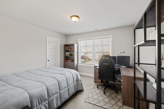 carpeted bedroom featuring baseboards and visible vents