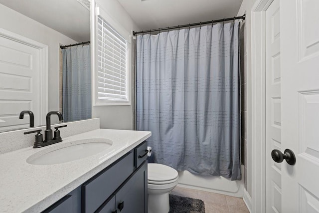 bathroom featuring toilet, vanity, shower / bath combo with shower curtain, and tile patterned floors