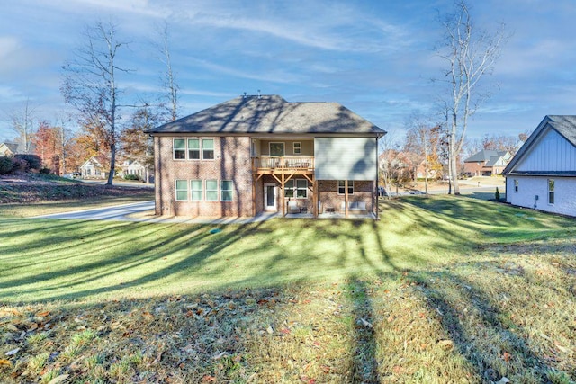 back of property with brick siding and a lawn