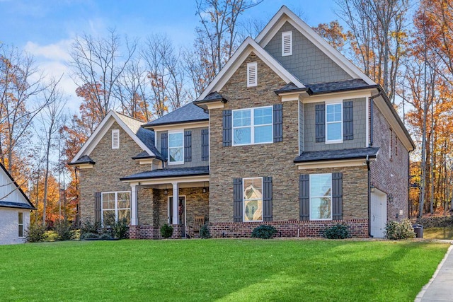 craftsman house with stone siding and a front yard