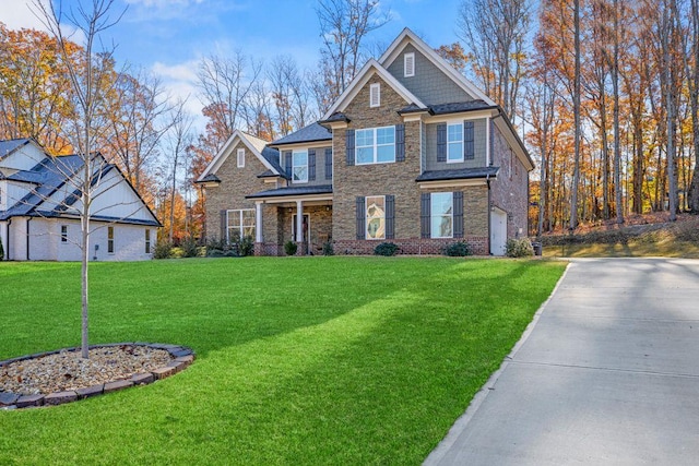 craftsman inspired home with driveway and a front lawn