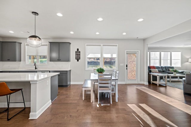 69 Saint Ives Cir, Winder, GA 30680 - kitchen with open floor plan, gray cabinetry, light countertops, healthy amount of natural light, and recessed lighting